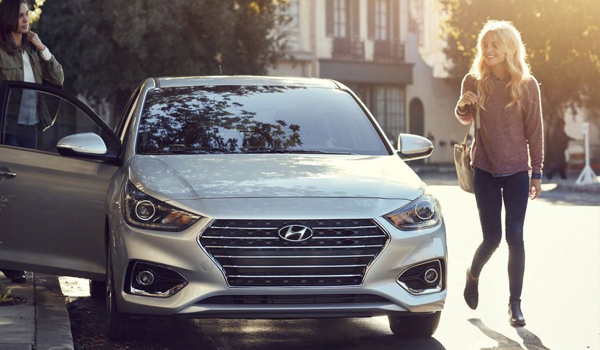 A customer takes a new Hyundai out for a test drive with her friend.